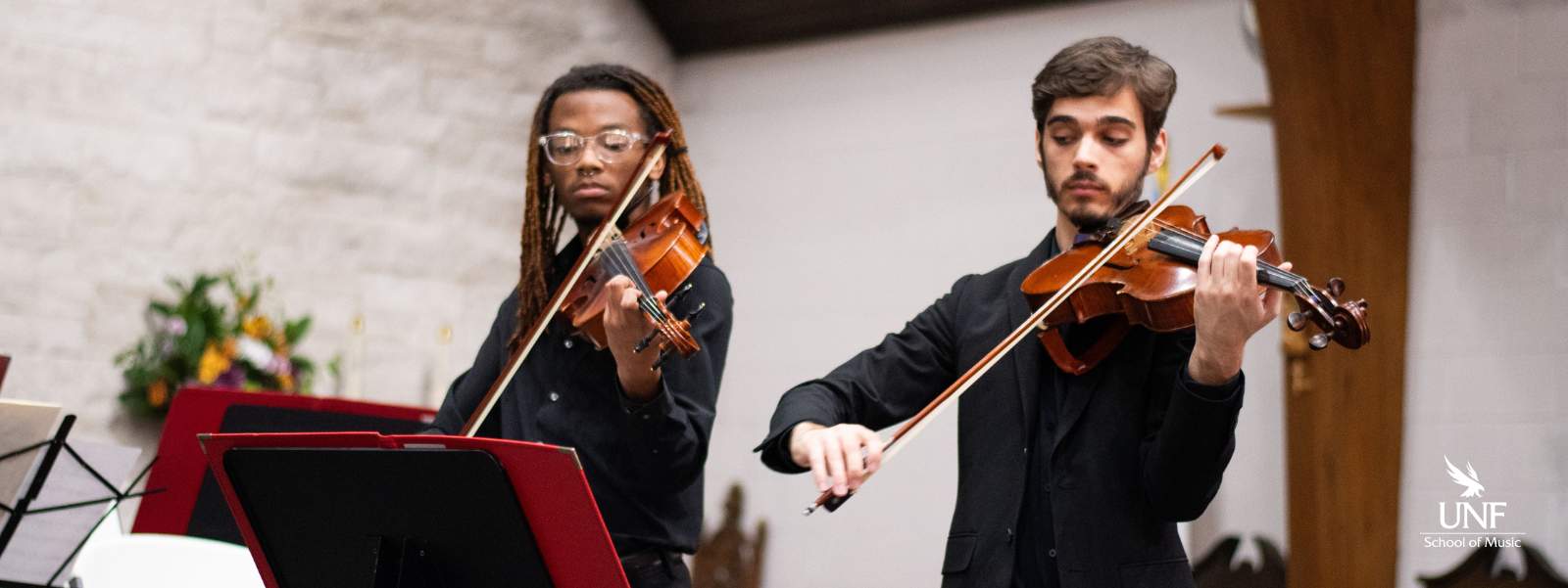 Two young men playing violas.