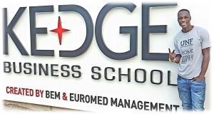 student in front of a sign in kedge, kedge business school created by bem and euromed management