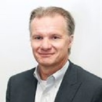 Headshot of Dag Naslund wearing a blazer and collared shirt
