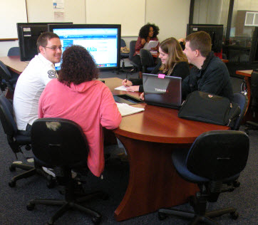 Four students sitting in the GP Lab Collaboration Area