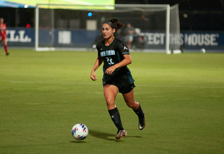 UNF student-athlete Zara Siassi kicking a soccer ball during a game