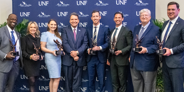 Alumni Award Winners Posing With Trophies