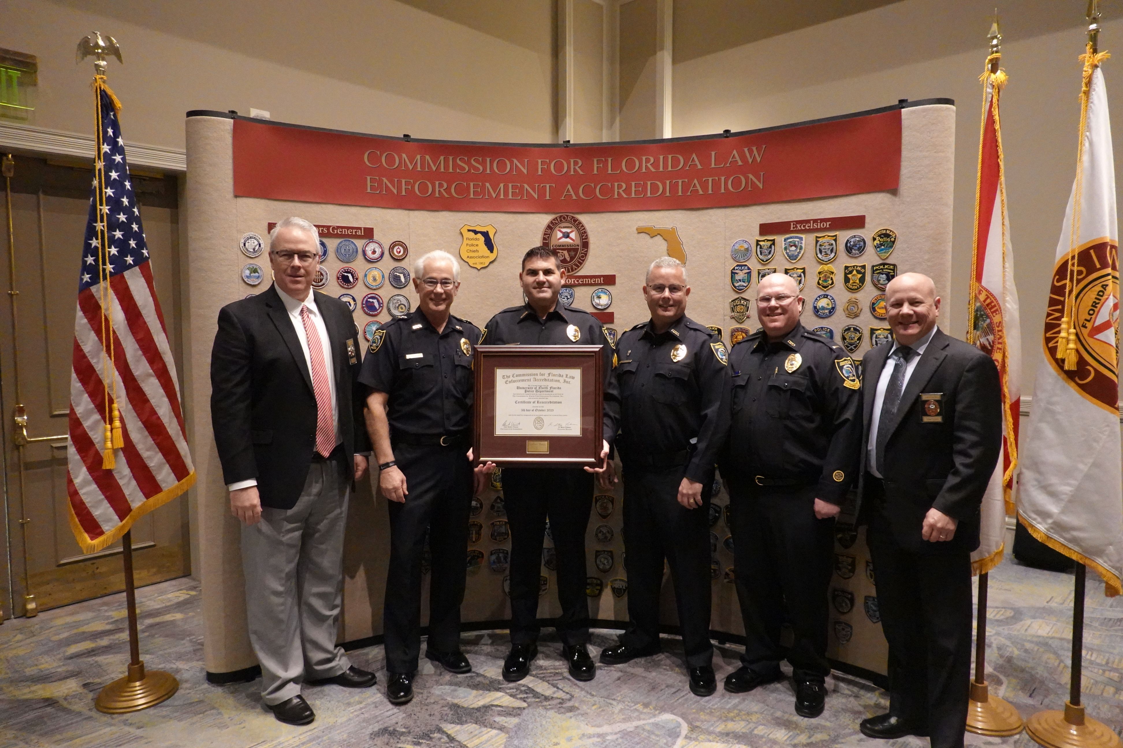 Members of the University Police Department displaying their certificate after being reaccredited by the Commission on Florida Law Enforcement Accreditation