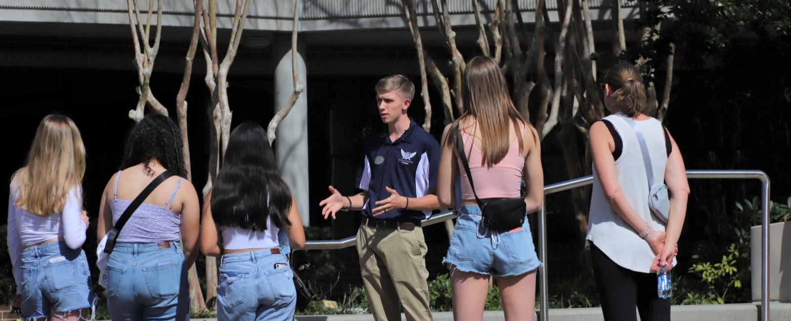 A UNF student tour guide talking to a tour group.