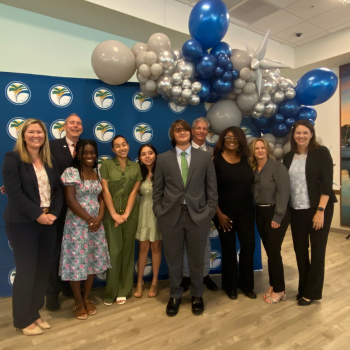 Team PUMP students in front of balloon backdrop