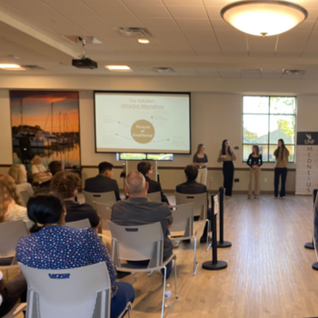 UNF Balloon centerpiece in forefront of student presentation