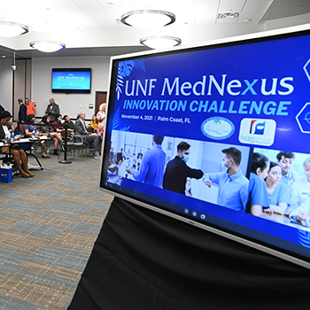 television screen with UNF MedNexus Innovation Challenge on it