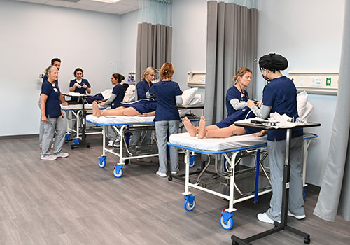 Group of students working in the Sim Lab
