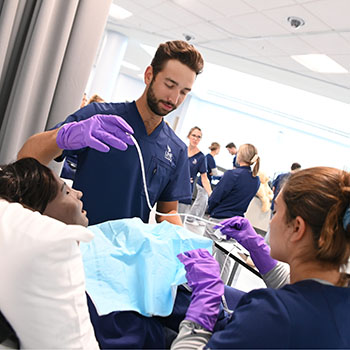 Two nursing students working in the MedNexus Simulation Lab