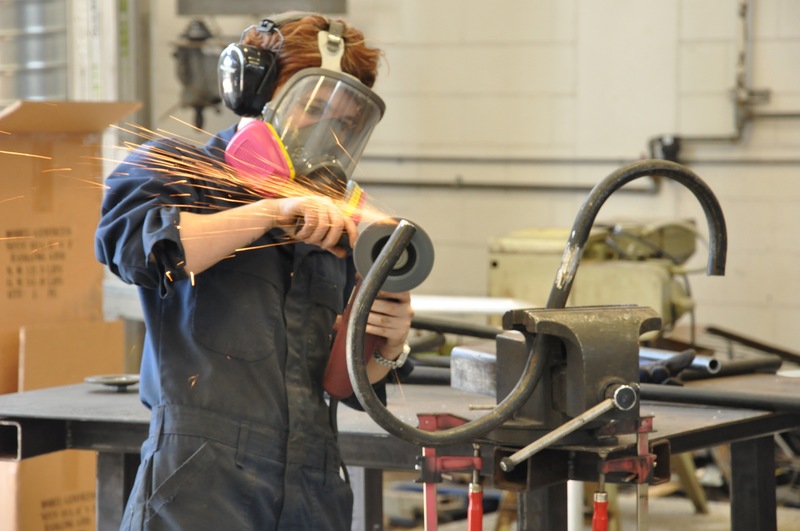 Student welding a metal sculpture