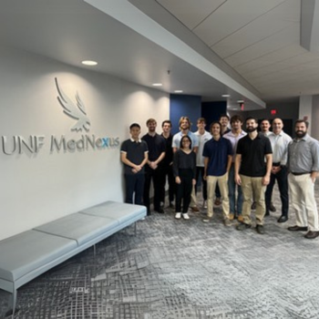 UNF Senior Design Engineering Project students in front of MedNexus Simulation Center
