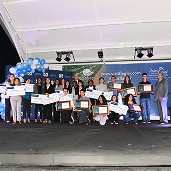 a group of students with framed awards