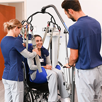 Four students working with equipment in the Sim Lab