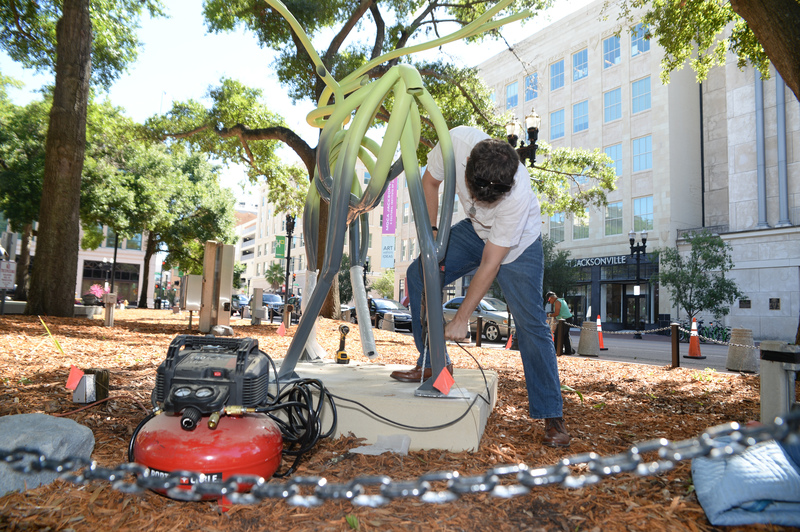 Student installing sculpture outside