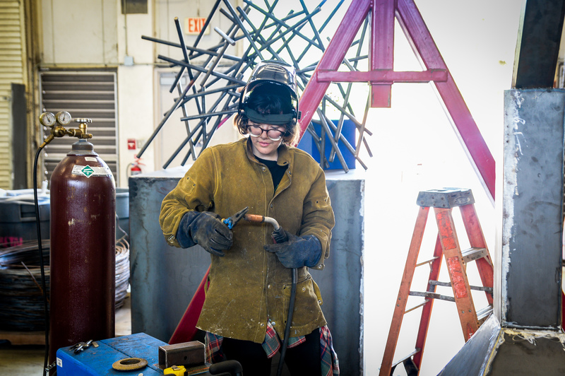 Student welding sculpture