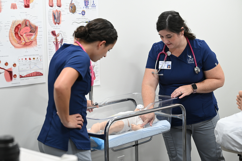 UNF Instructor and Nursing student with simulation baby