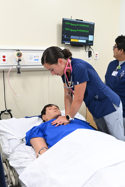 UNF Student performing chest compressions on mannequin