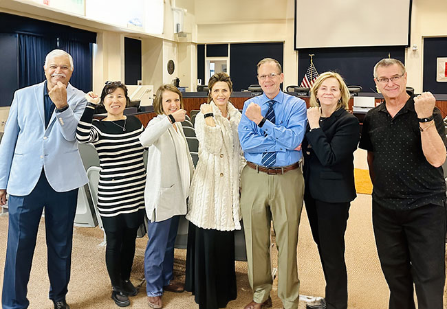 a group of people showing off Fitbits