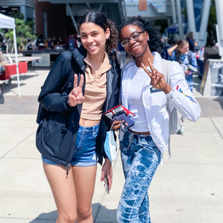 Two students hold up peace signs