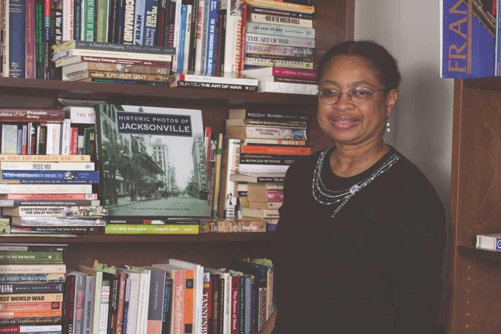 dr. williams in front of a bookshelf