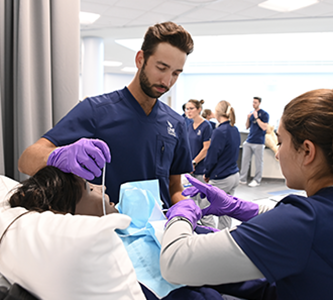 two people working on a simulated patient
