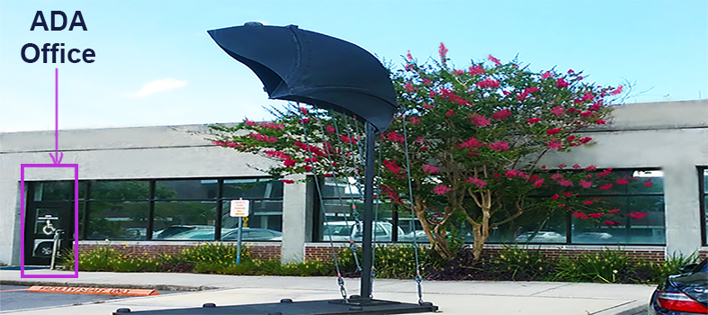 ADA Office front door with flower tree and metal statue