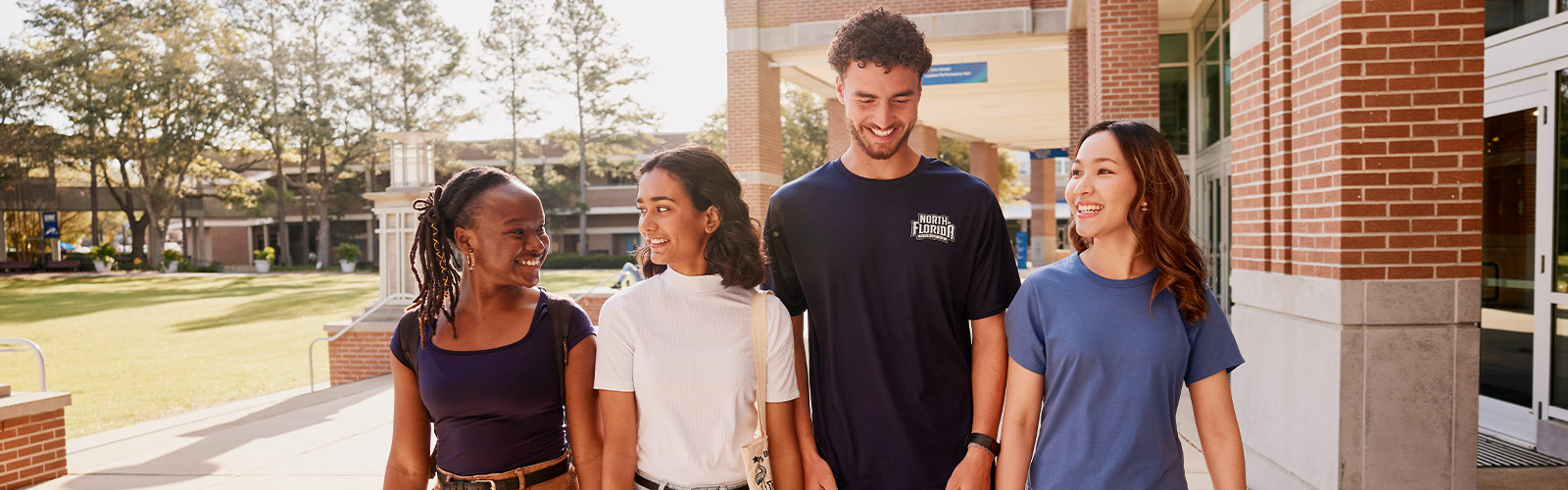 Four students walking on UNF's campus