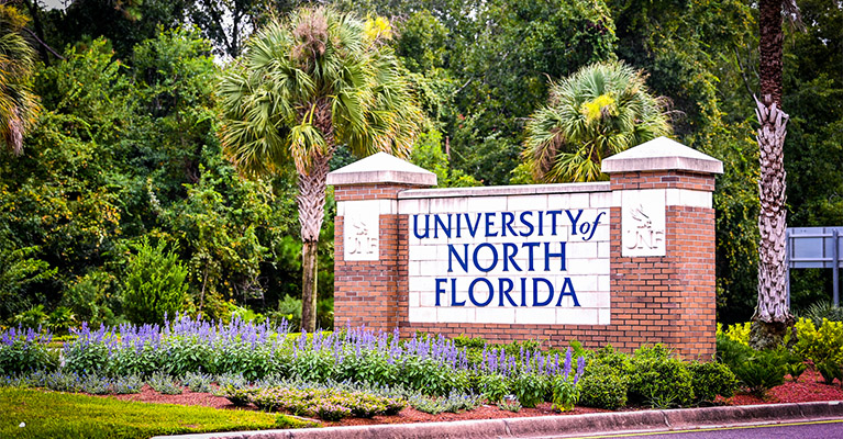 UNF entrance sign surrounded by plants