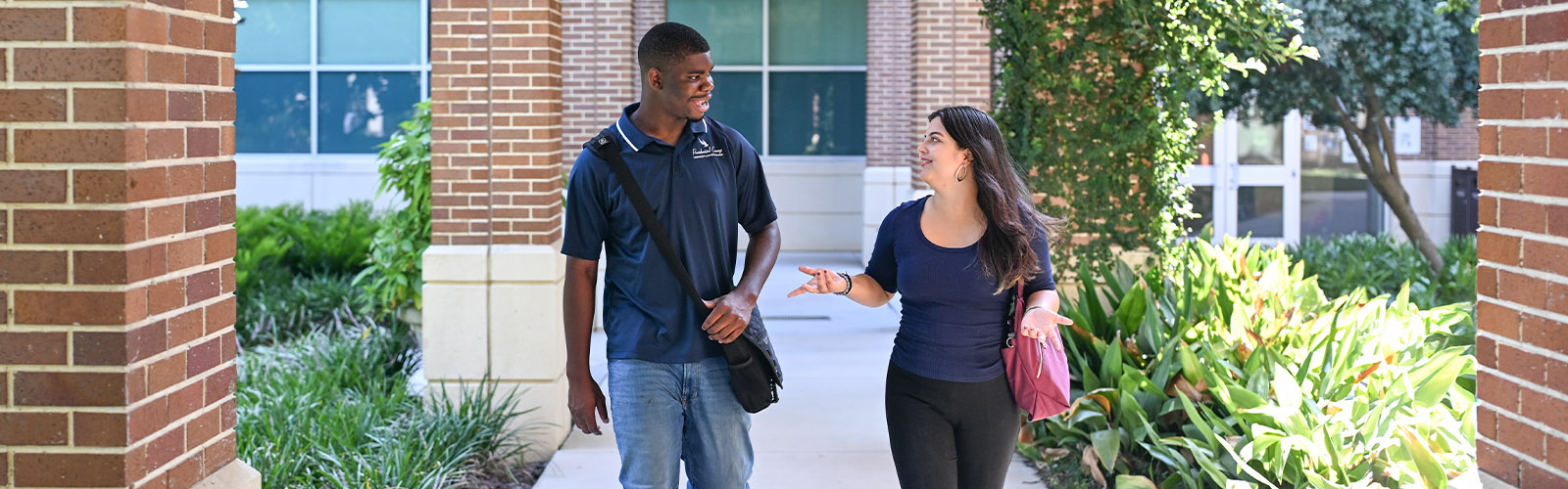 Two students walking on UNF's campus and talking