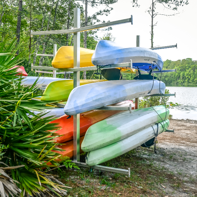 Rack of kayaks at the UNF Nature Preserve with the lake in the background