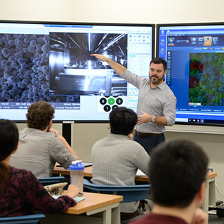 Faculty member explains images on screen