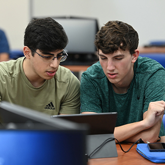 Two computing students collaborate on a Windows Surface