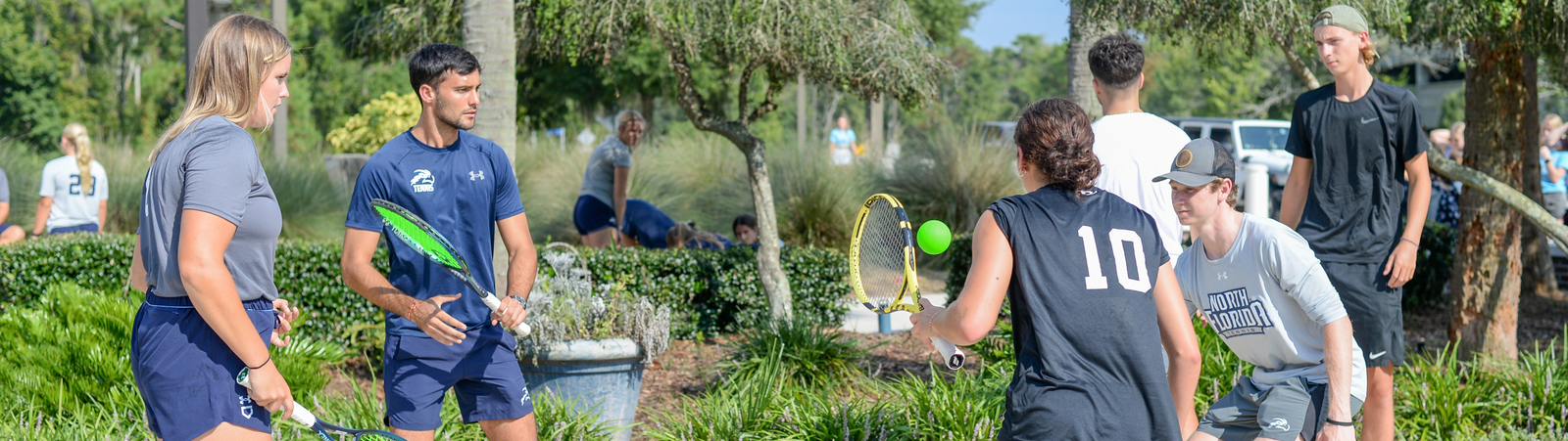 four people playing tennis