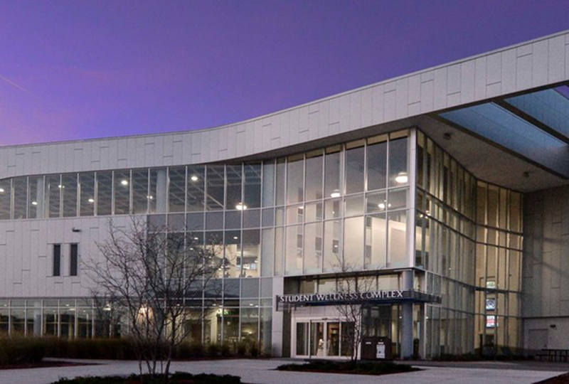 student wellness complex building entrance at dusk