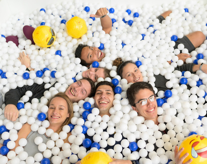 seven students having fun in a ball pit