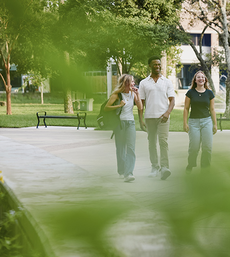 students walking and smiling on campus