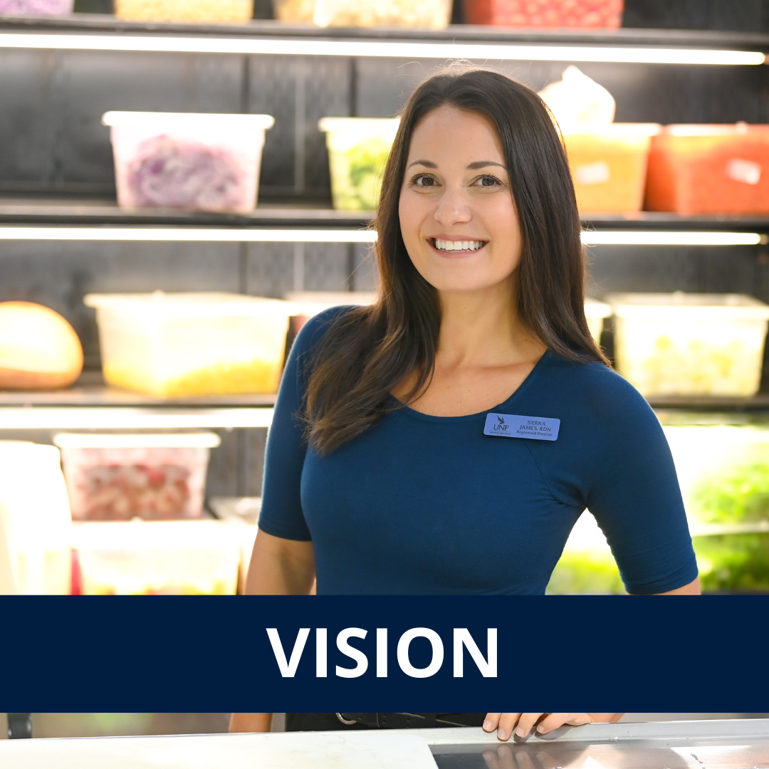 UNF nutrition student smiling standing in front of food bins