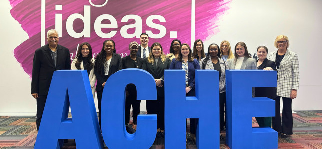 Leadership students standing in front of ACHE sign