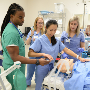 Nursing students working on mannequin