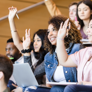 students in class raising hands