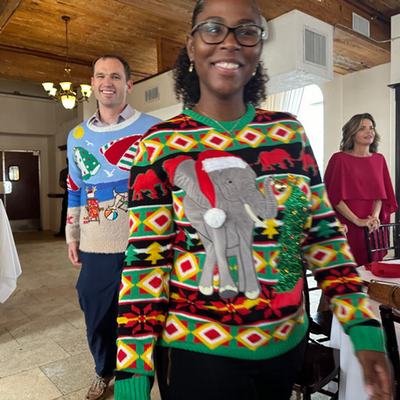 Faculty wearing a elephant ugly christmas sweater for a contest