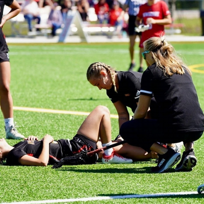 MSAT Alumni checking on an athlete on the field