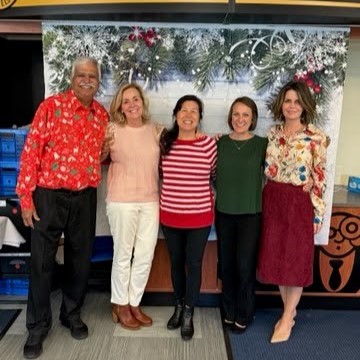 Five people standing and smiling at the BCH holiday party