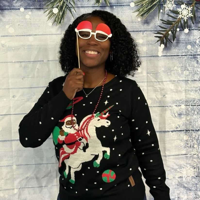 Lady holding prop santa glasses