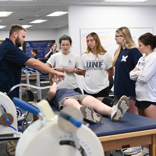 Kinesiology professor instructing a class of students