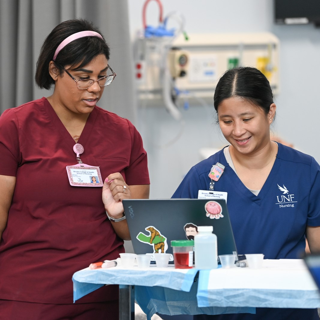 Nursing faculty instructing a nursing student