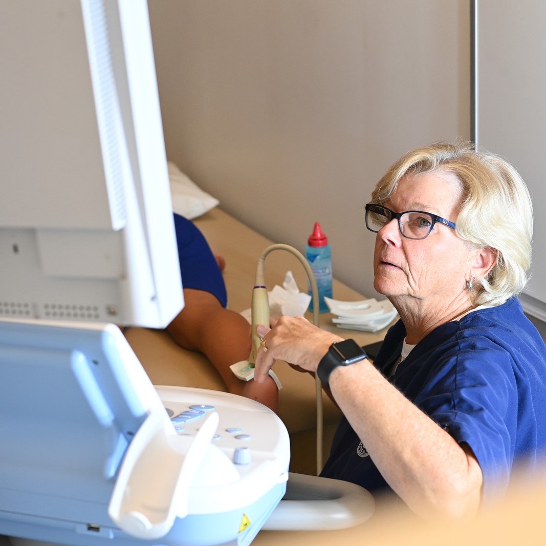 PT Faculty conducting an ultrasound on a leg