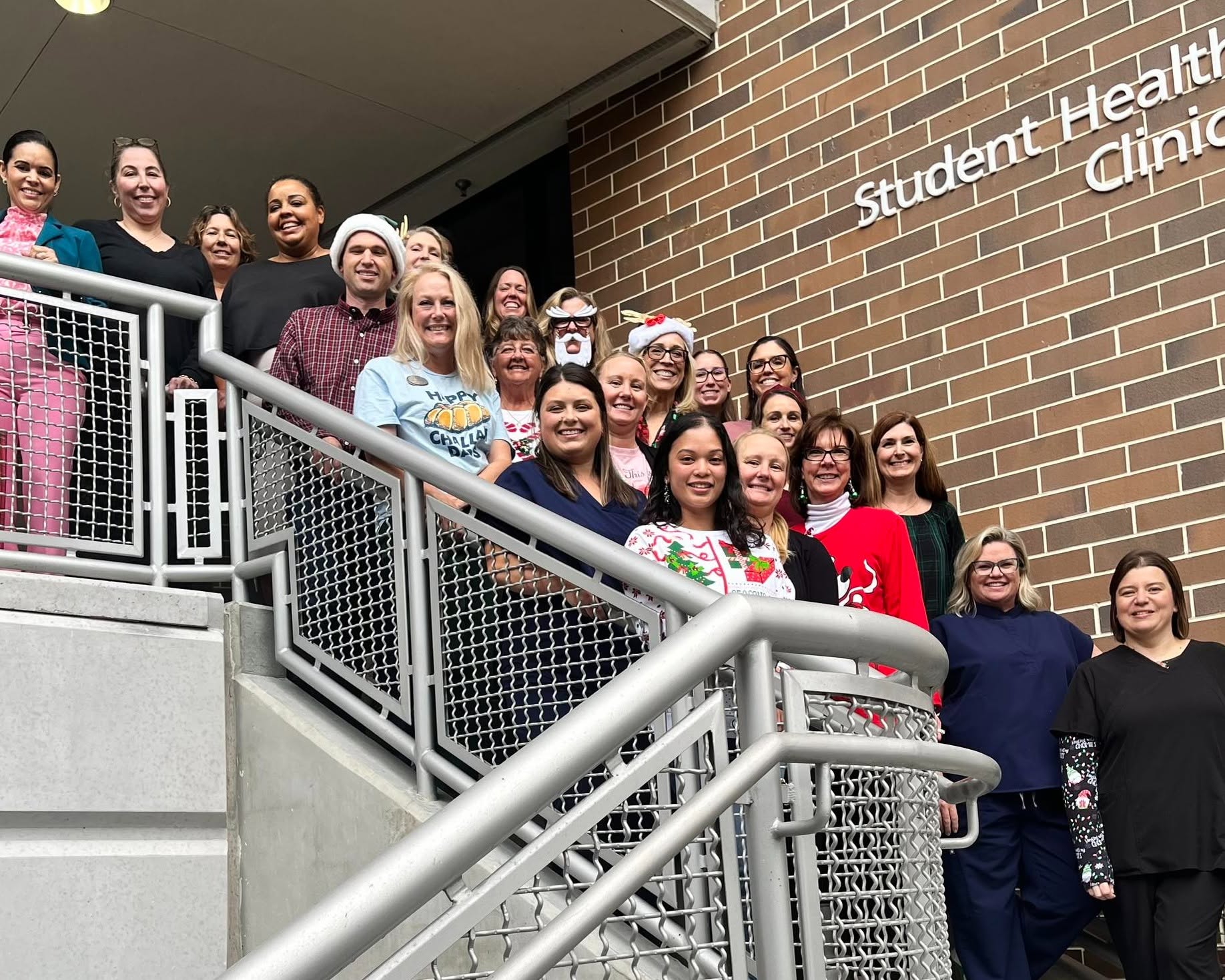 UNF student Health services staff group standing outside on the stairs