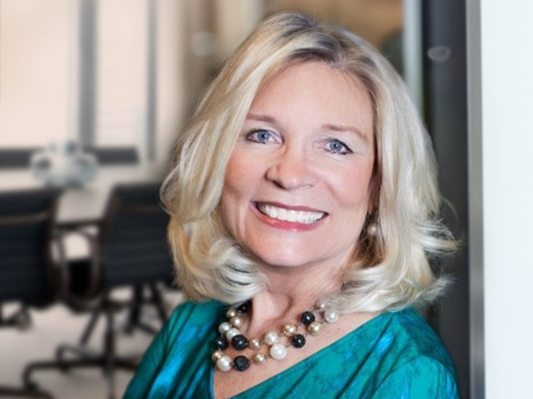 Christine Cauffield leaning against a wall smiling