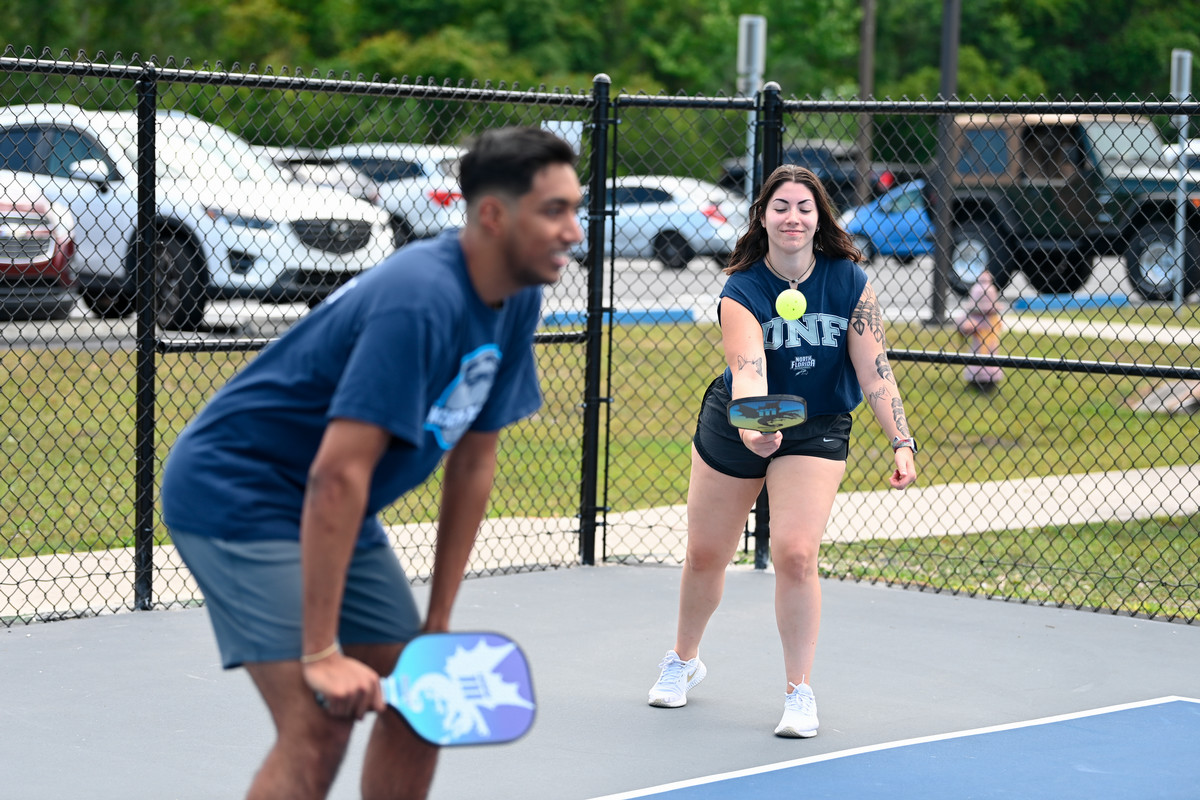 Two unf students playing pickleball